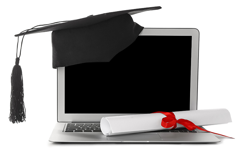 Computer with graduation cap and diploma